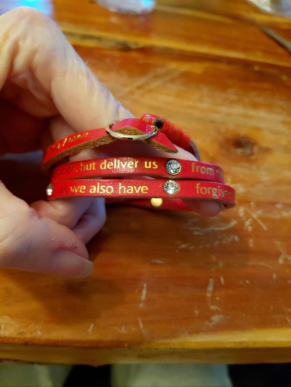 Sundance Red leather wrap bracelet with gold foil lettering. "THE LORD'S PRAYER"